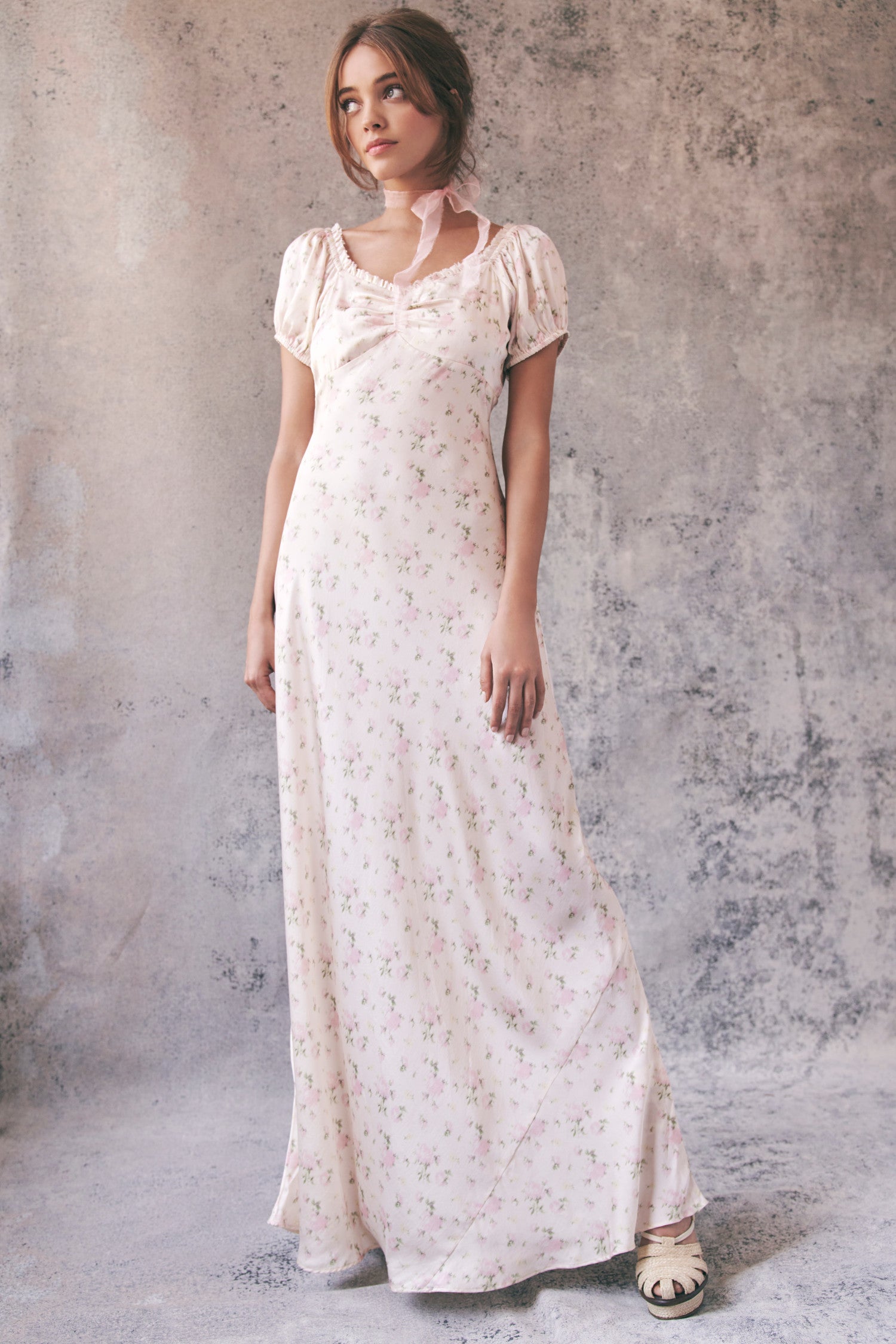 Model wearing cream floral maxi dress