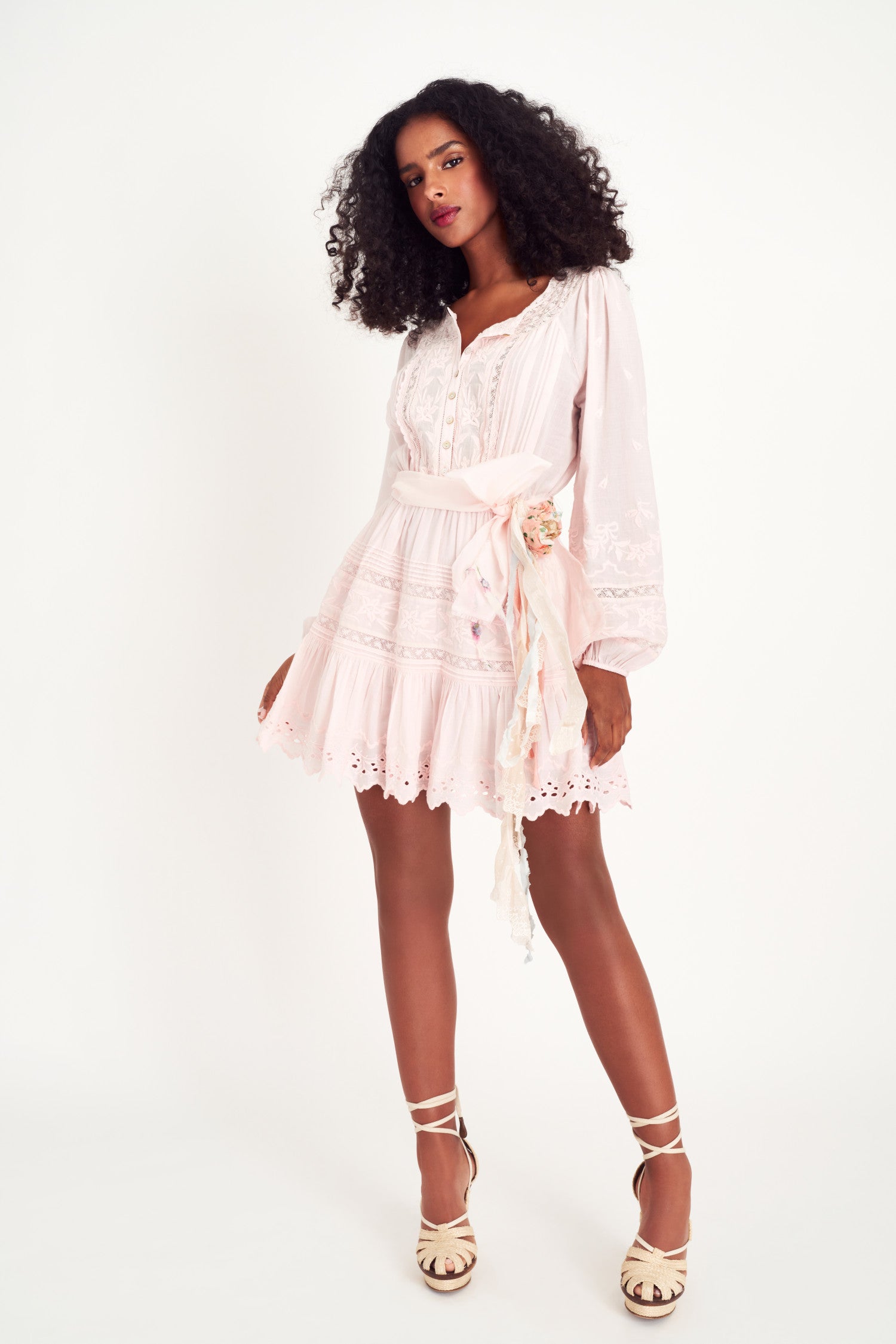 Model wearing pink long sleeve mini dress