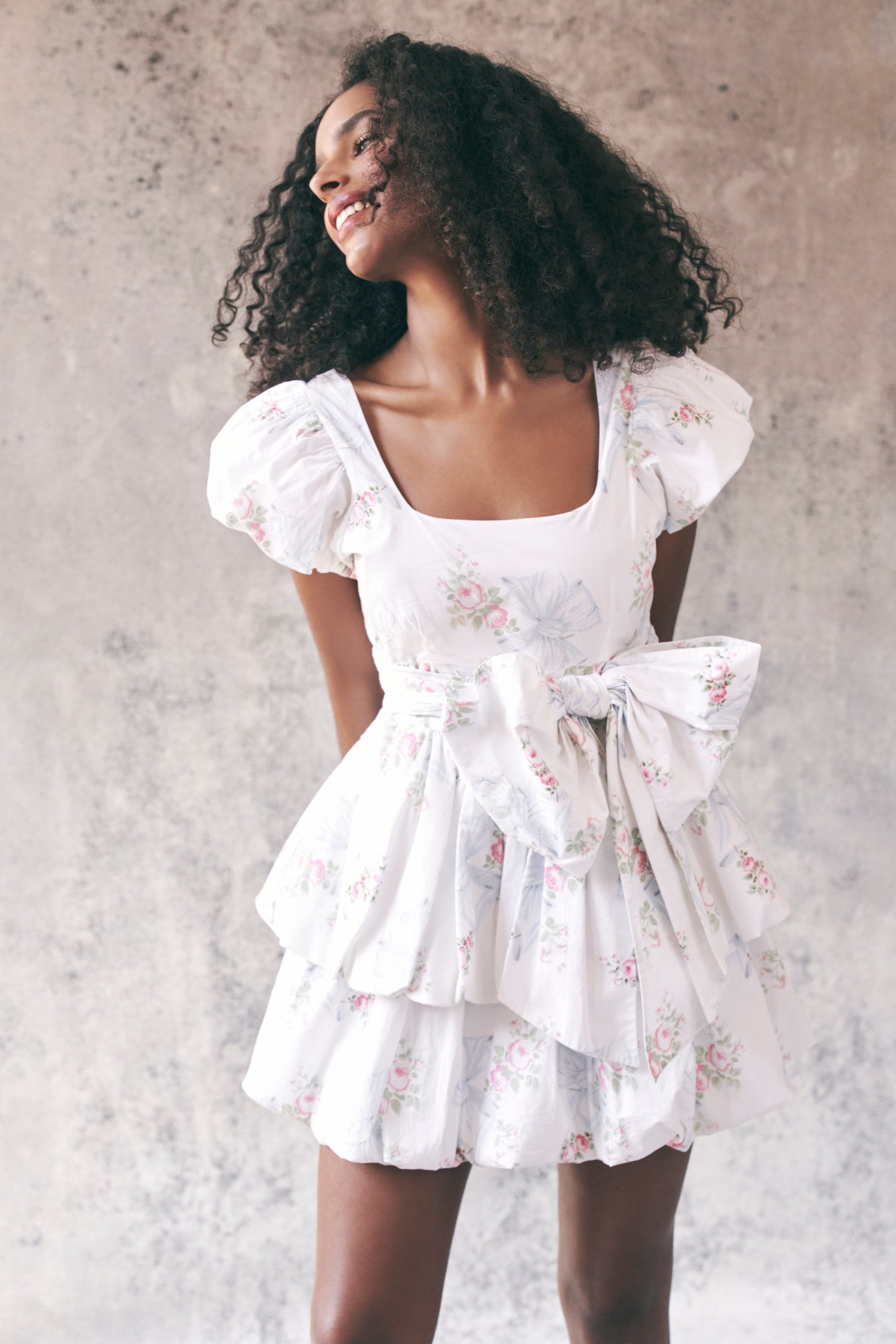 Model wearing floral babydoll mini dress