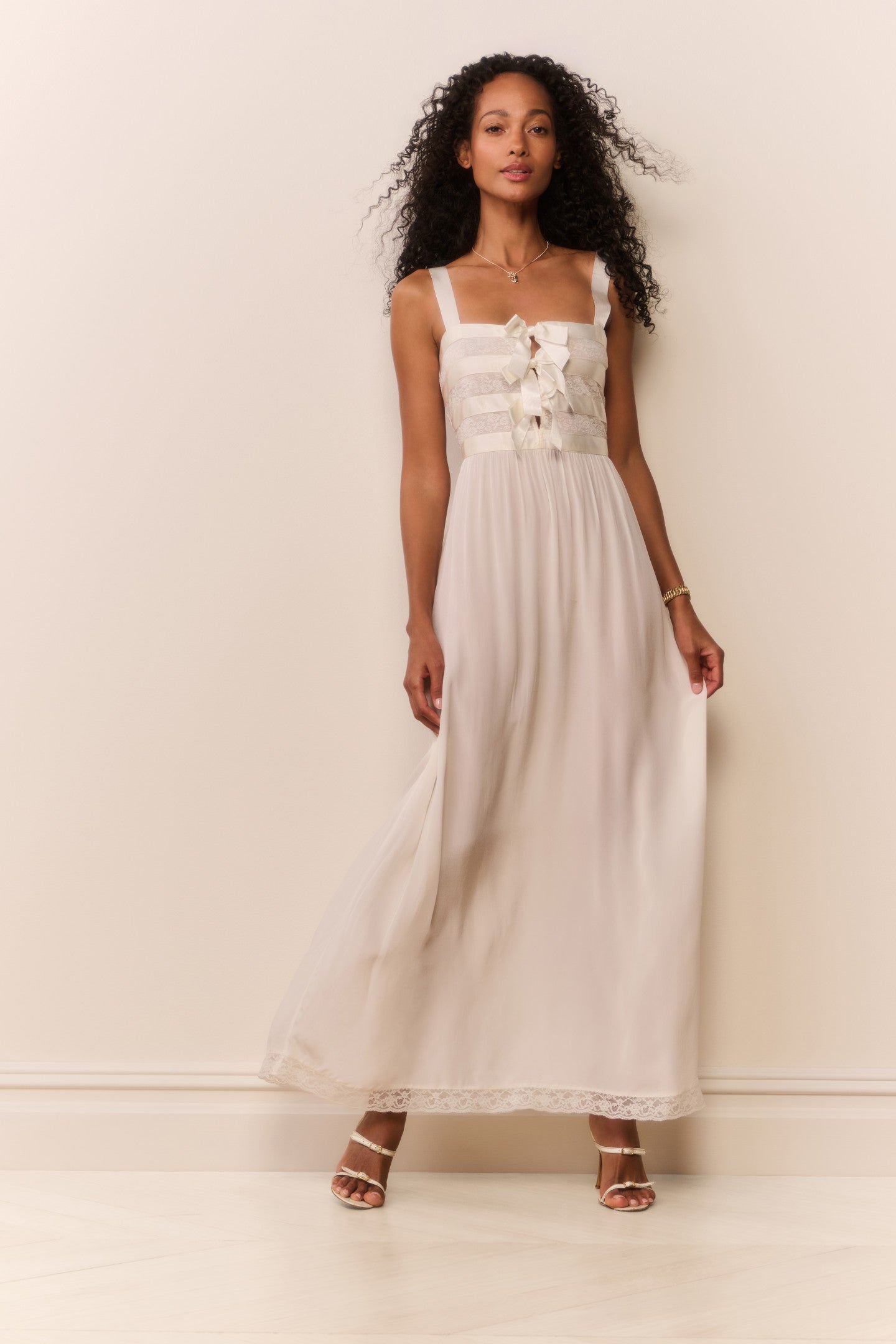 Women sitting in grass field wearing LoveShackFancy Slip Dresses