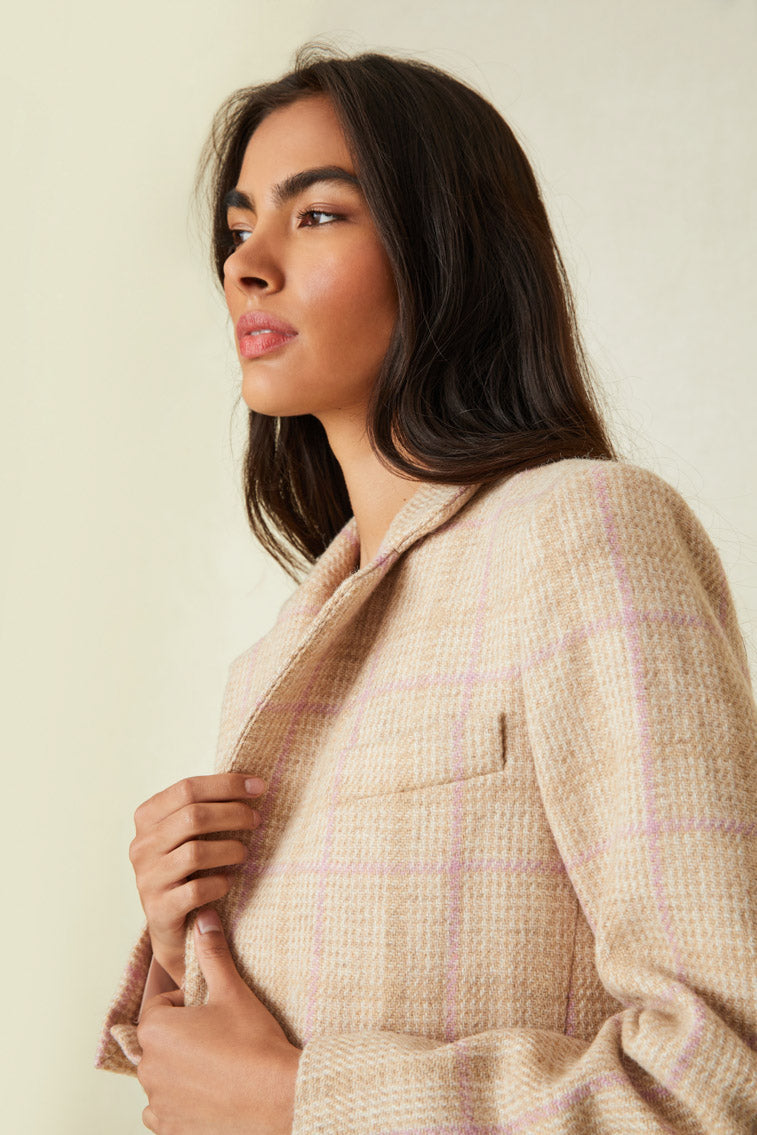 boyfriend blazer arrives slightly oversized and features feminine touches like soft pink colorway stripes. A soft chiffon bias trim details the sleeve openings while satin covered buttons provide a contrasting color