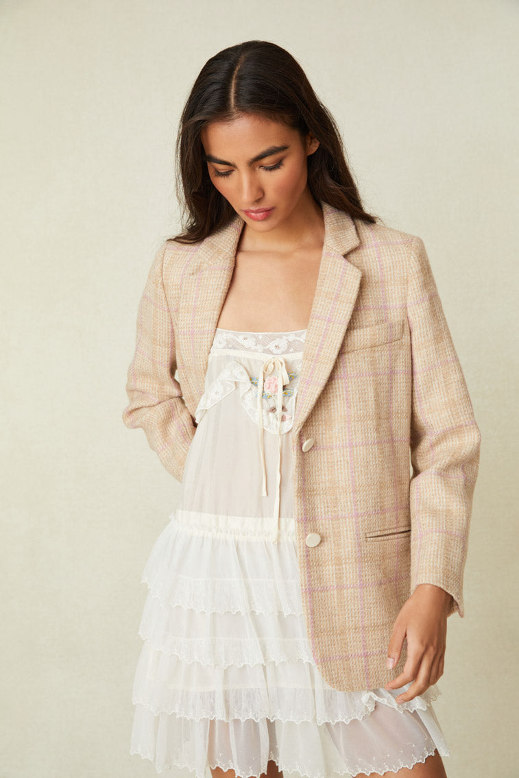 boyfriend blazer arrives slightly oversized and features feminine touches like soft pink colorway stripes. A soft chiffon bias trim details the sleeve openings while satin covered buttons provide a contrasting color