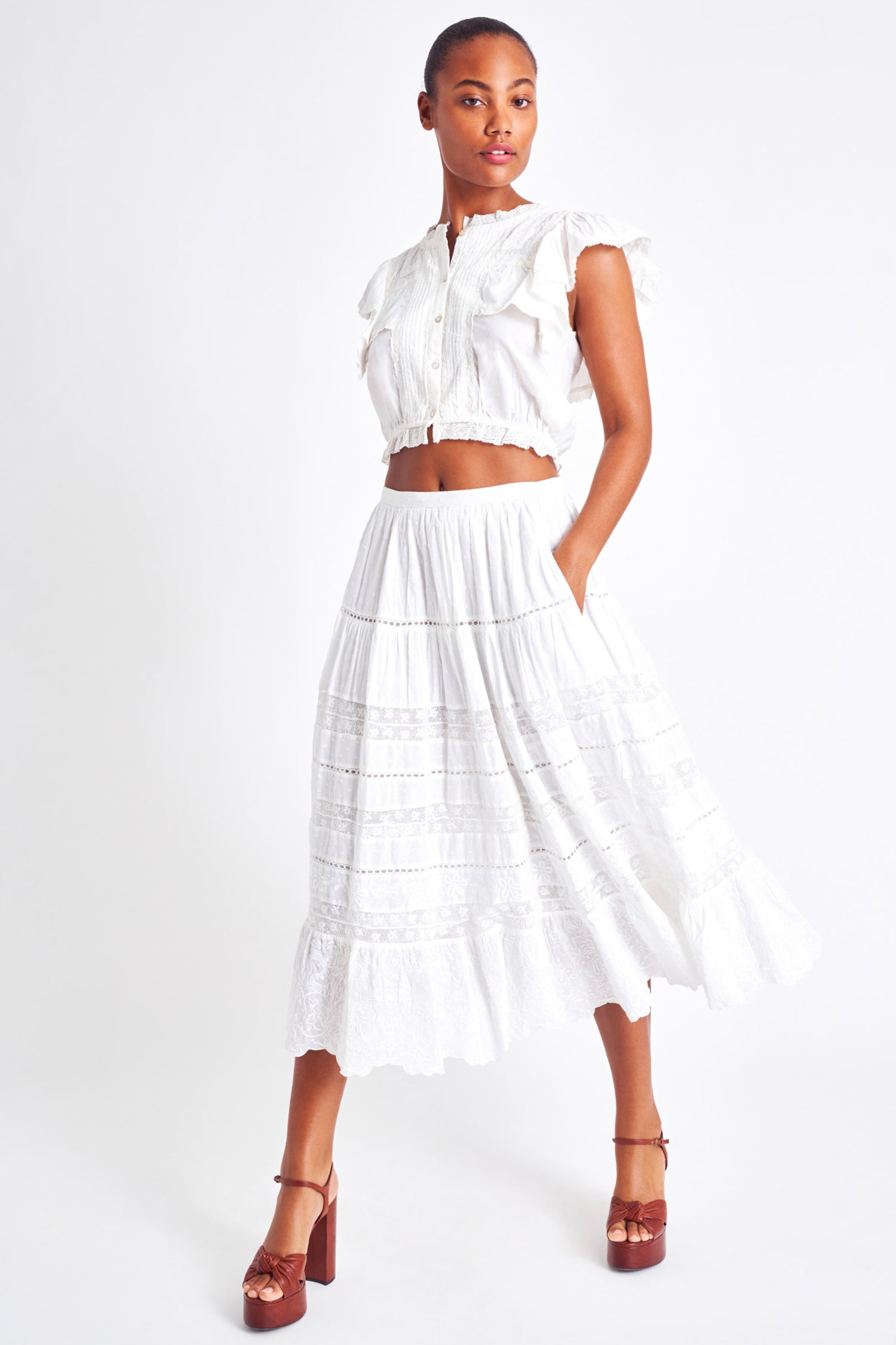 White midi skirt with lace detailing throughout the skirt as well as on the bottom trim