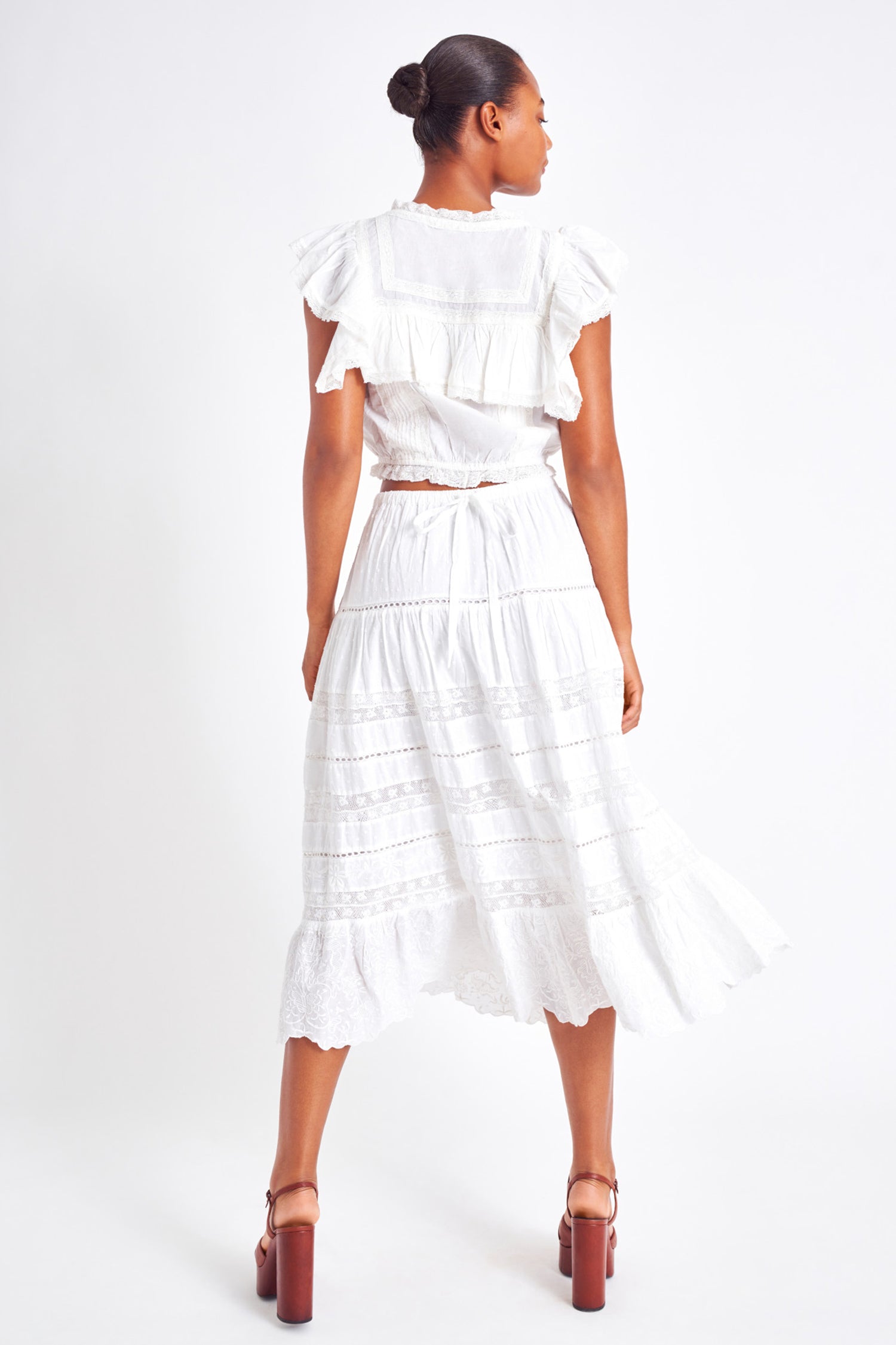 White midi skirt with lace detailing throughout the skirt as well as on the bottom trim