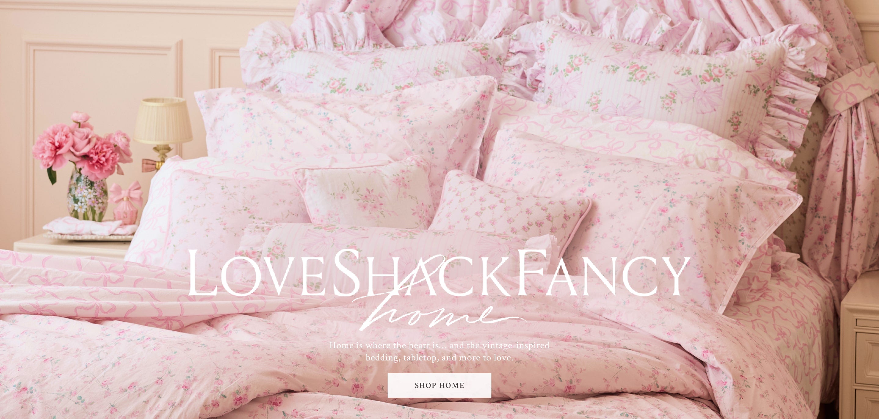 A bed with LoveShackFancy pillows, sheets, and covers. Shop Home.