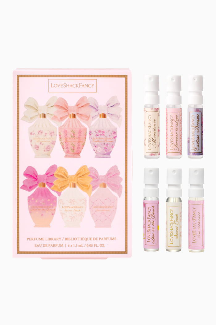 Set of LoveShackFancy perfume bottles with packaging on a white background