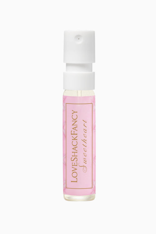 Pink rollerball bottle with white cap on a white background