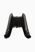 Black sheer blouse with lace details on a white background