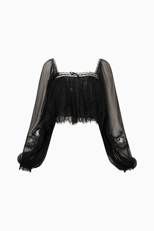 Black sheer blouse with lace details on a white background