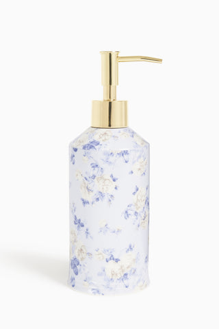 Floral-patterned soap dispenser with gold pump on a white background