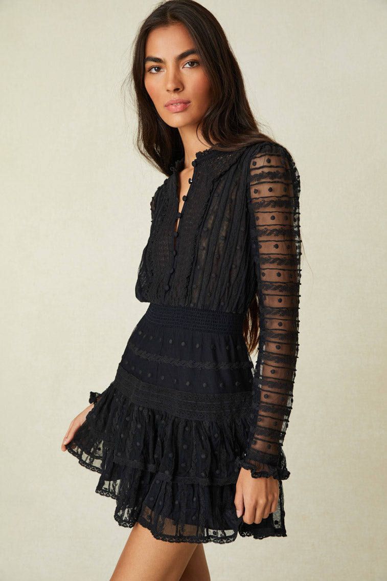 Long sleeved mini features stitch work intertwined with custom lace and a tiered ruffle skirt.