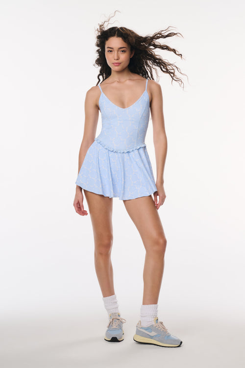 Woman wearing a light blue dress with a white background