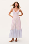 Woman wearing a light pink and blue dress sleeveless long dress on a white background