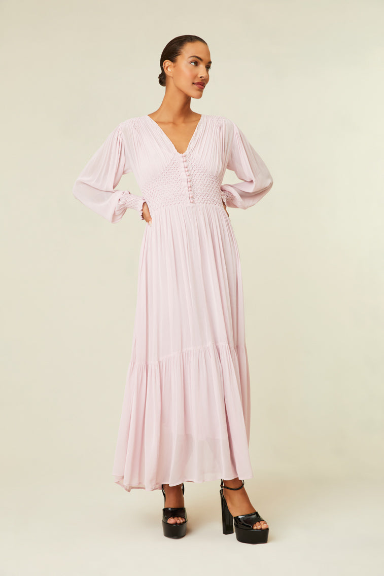 Maxi dress features diamond smocking at the bodice and shoulder.