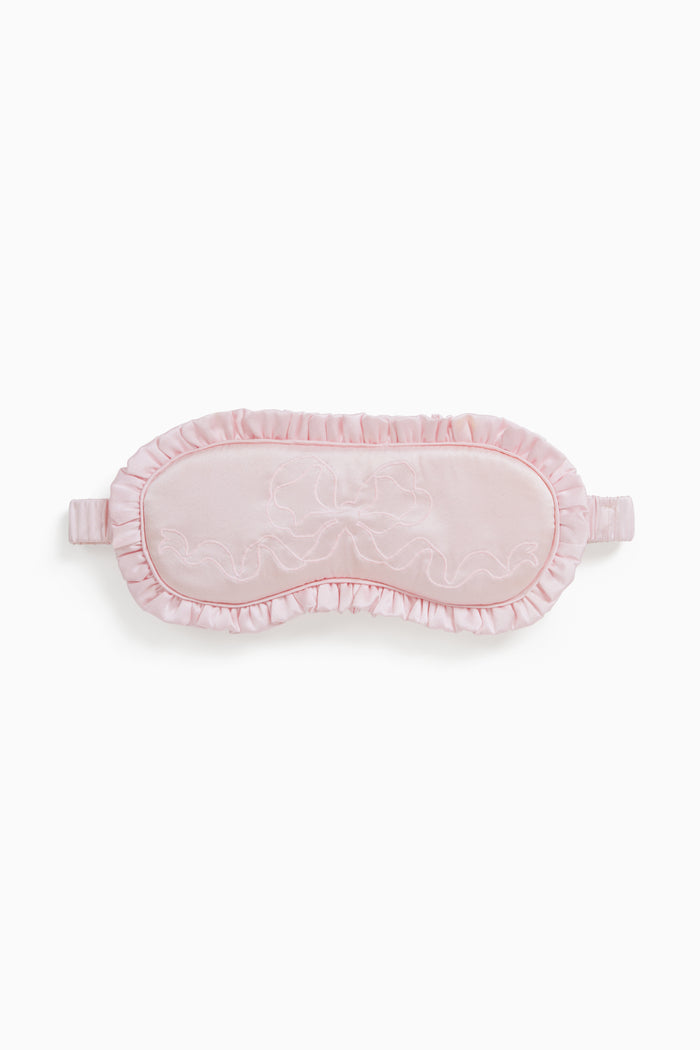 Pink eye mask with lace details on a white background