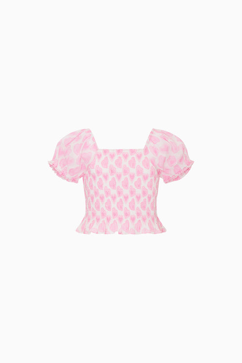 Pink patterned top on a white background
