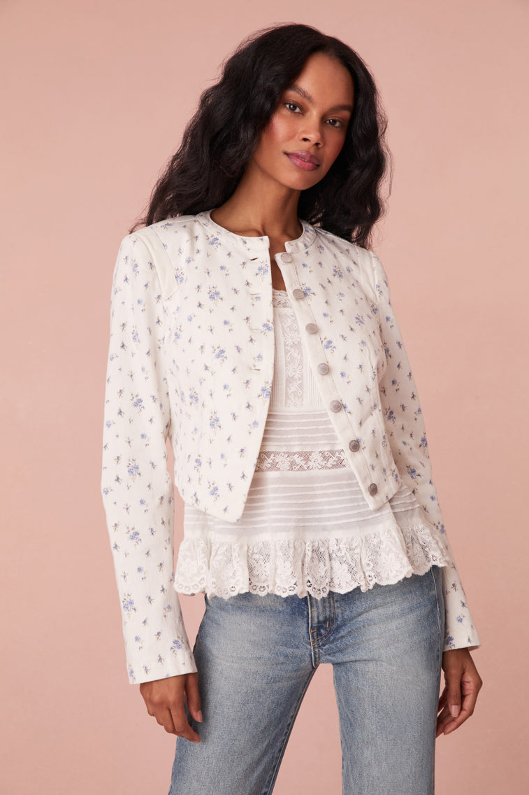 Cropped, white denim jacket featuring a pocono ikat floral print. Includes a cut-out detail on the front and custom LoveShackFancy logo buttons.