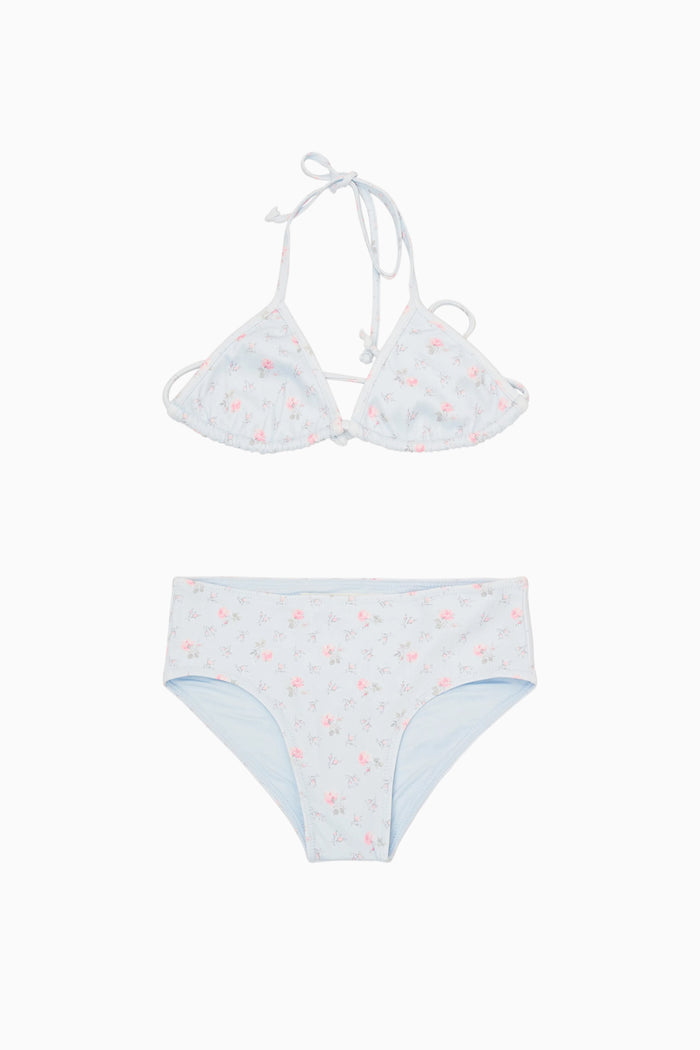 White bikini set with small red flowers on a white background