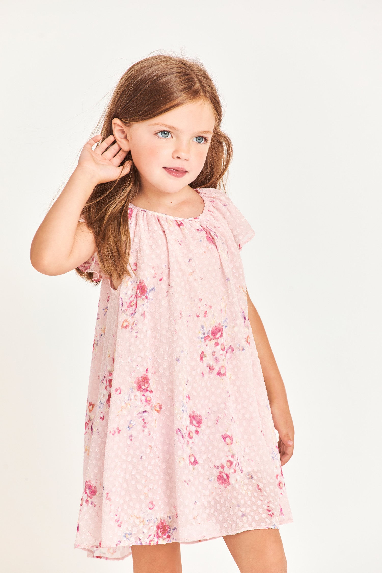 Model wearing kids pink mini dress