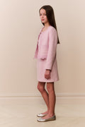 Girl wearing pink linen mini dress with matching lace trim evening jacket
