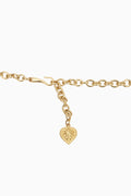 Gold belt with a heart-shaped charm on a white background