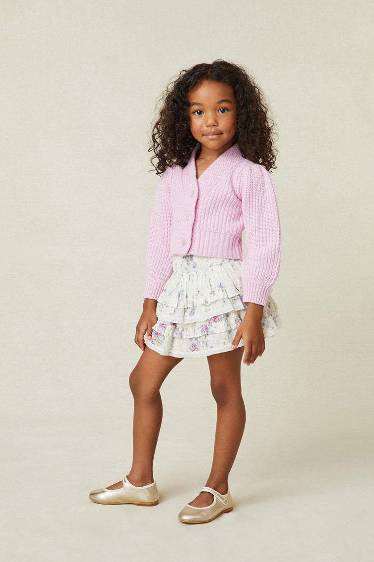 Model wearing girl's white and purple floral ruffle mini skirt