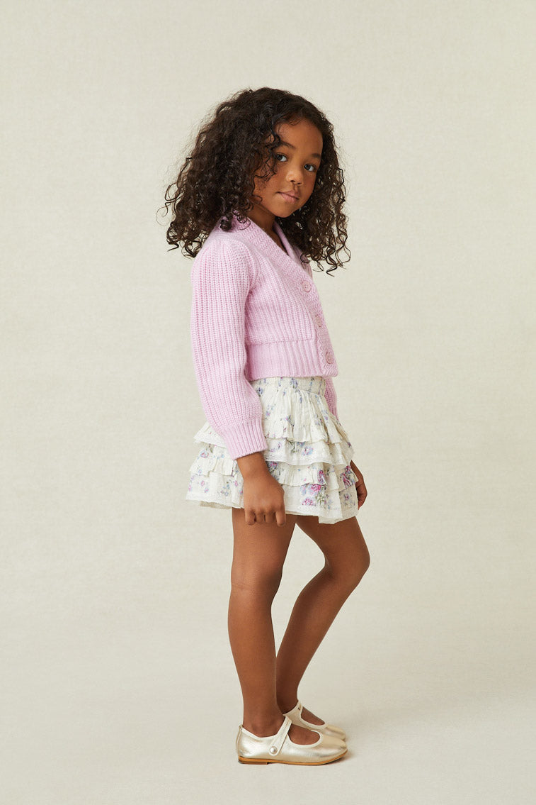 Model wearing girl's white and purple floral ruffle mini skirt