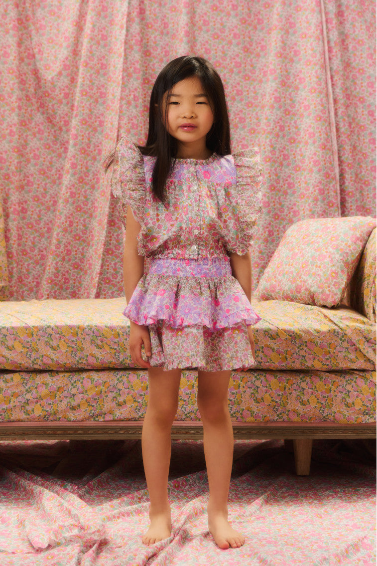Two-tiered ruffle skirt featuring a two-toned floral mixed print and a smocked waistband.