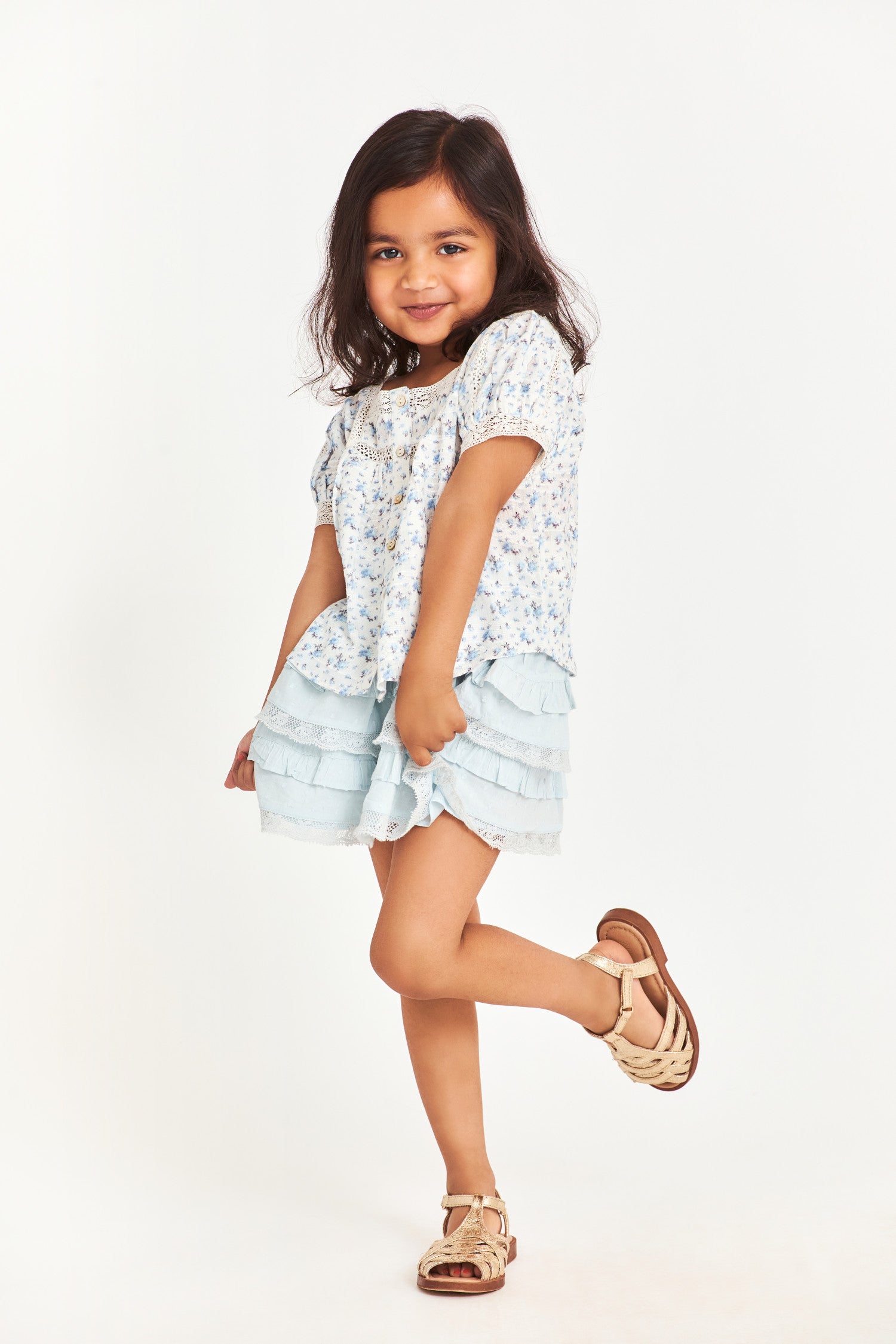 Model wearing kids blue mini skirt