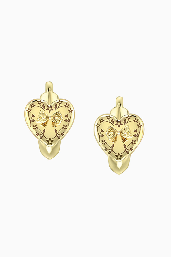 Gold heart-shaped earrings with intricate designs on a white background