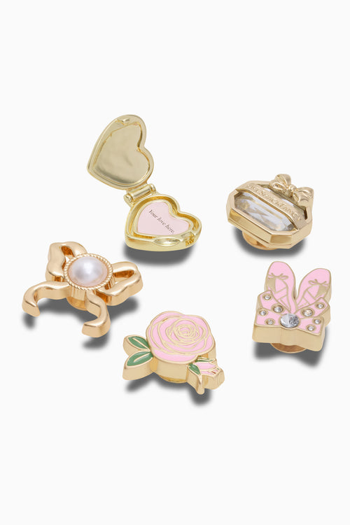 Set of decorative charms with floral and bow designs on a white background