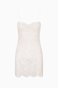 White sleeveless dress with lace pattern on a white background