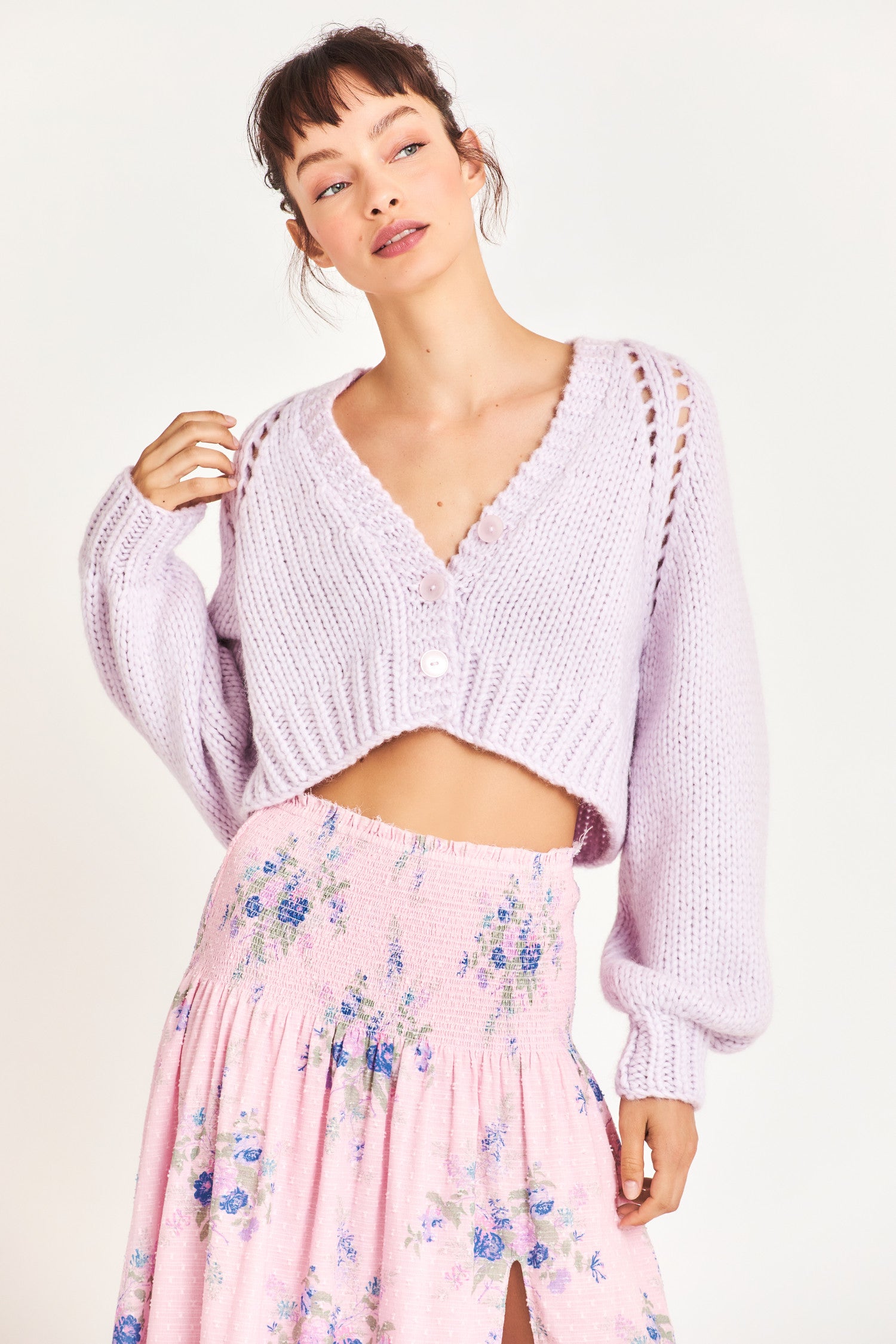  Knitted cropped sweater in a beautiful purple color featuring puffy sleeves for a comfortable feel as well as three buttons down the middle 