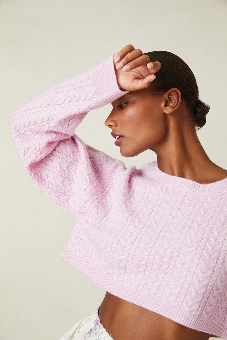Model wearing pink cable knit crop sweater