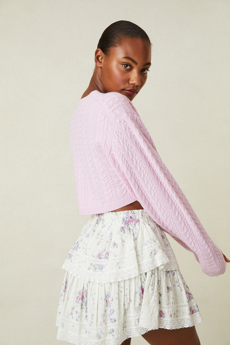 Side image of model wearing pink cable knit crop sweater