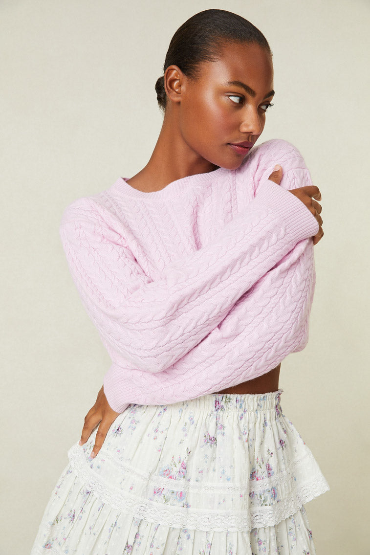 Model wearing pink cable knit crop sweater