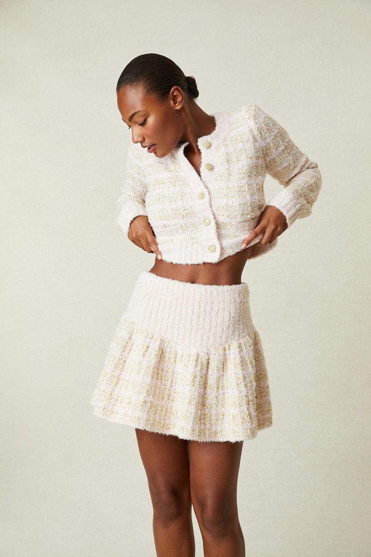 Model wearing cream tweed mini skirt