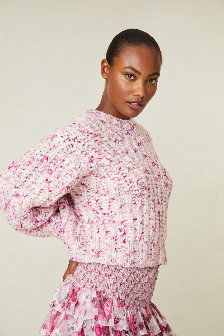 Model wearing multi-tone pink knit sweater