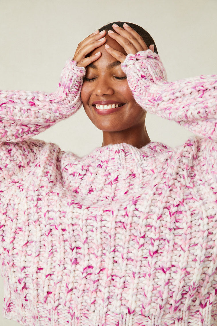 Model wearing multi-tone pink knit sweater