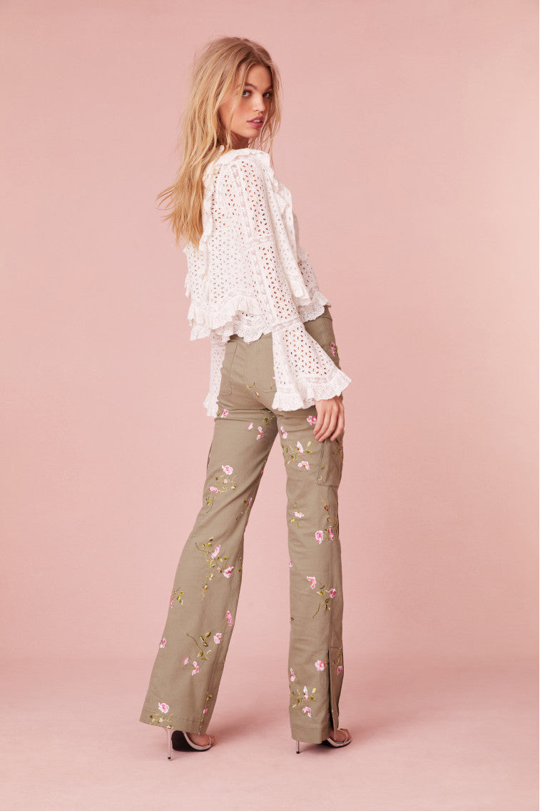 Olive green slim fit and full length pants with pink flowers embroidered all over. Includes a slit detail on the sides and cargo pockets.