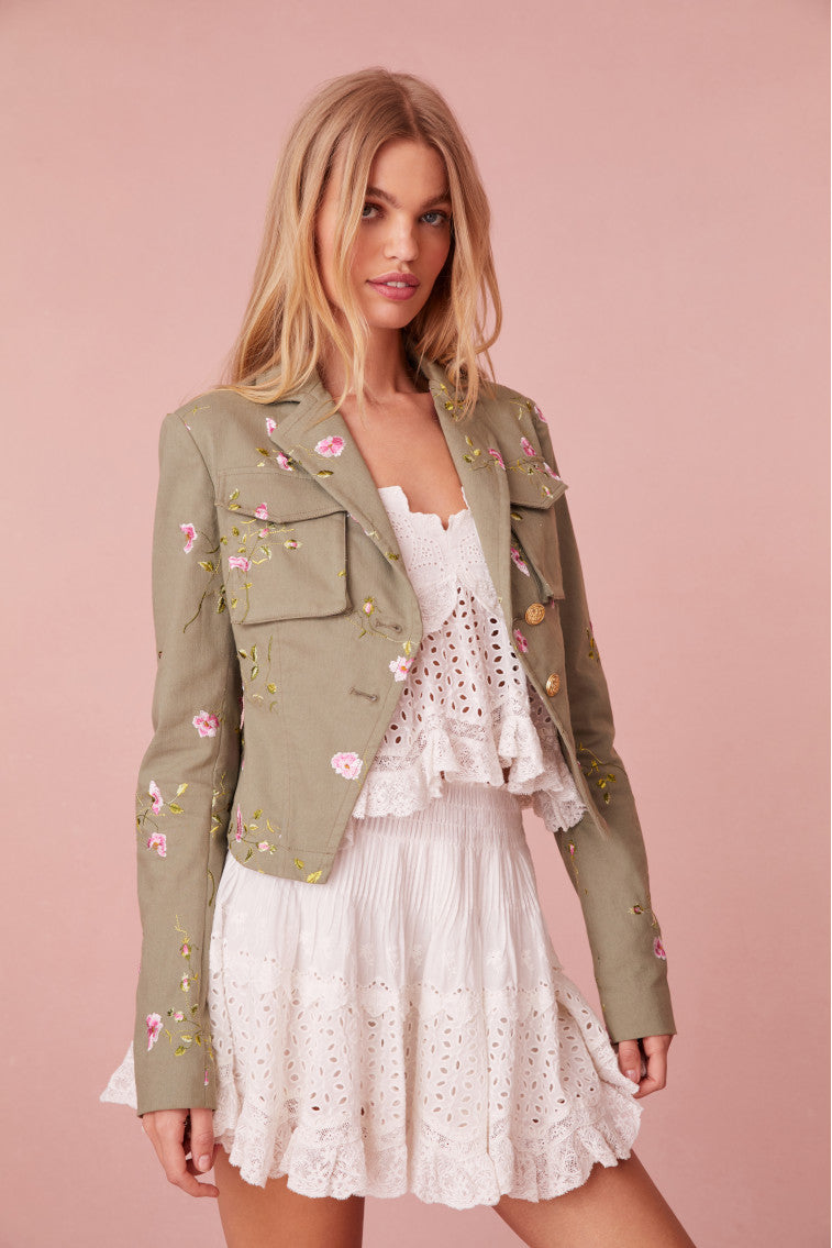 Floral military jacket with pockets on the front and custom gold military buttons at the center. This piece has a 40s-inspired waist with peplum details and princess seams.