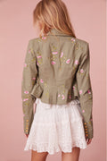 Floral military jacket with pockets on the front and custom gold military buttons at the center. This piece has a 40s-inspired waist with peplum details and princess seams.