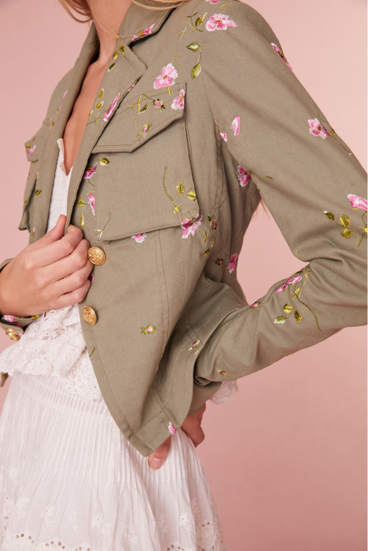 Floral military jacket with pockets on the front and custom gold military buttons at the center. This piece has a 40s-inspired waist with peplum details and princess seams.