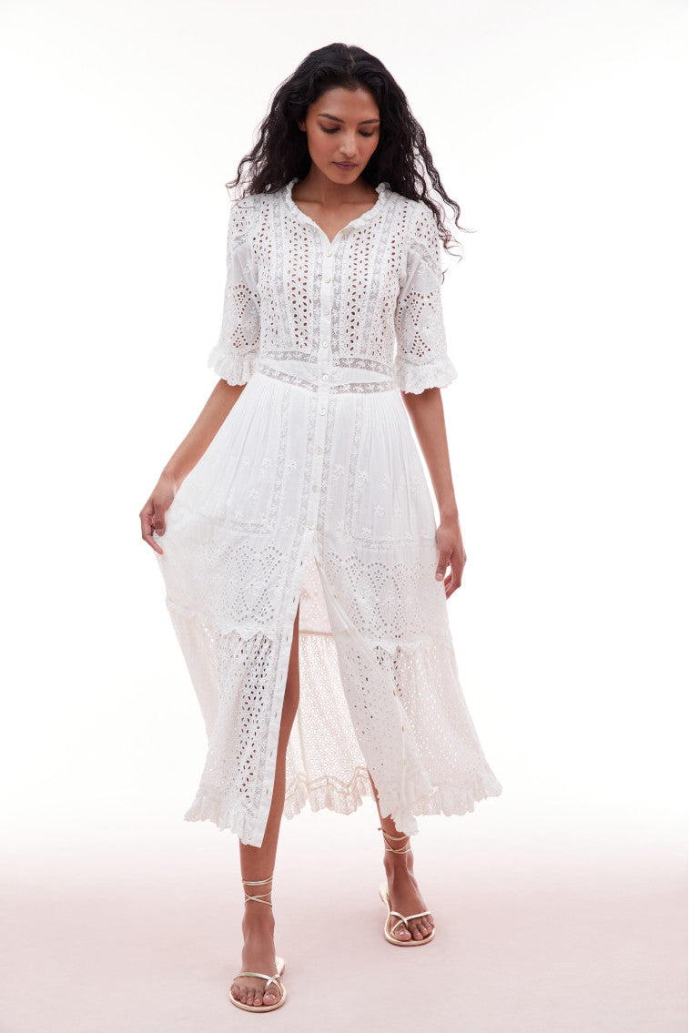 Midi dress with elbow length sleeves and a button down bodice. Features eyelet and laces above a waist yoke that descends to a sweeping skirt with pintucking details and an eyelet flounce.