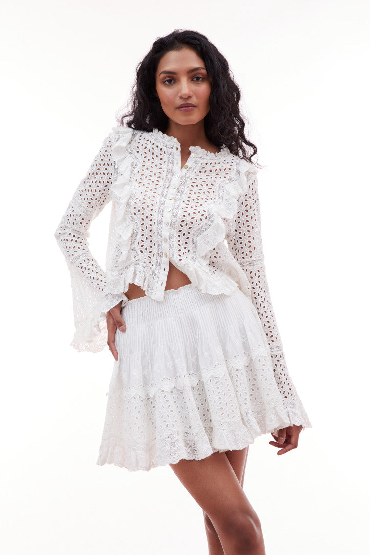 Mini skirt with eyelet details featuring a smocked waistband, and tiny lace details at the sweep.