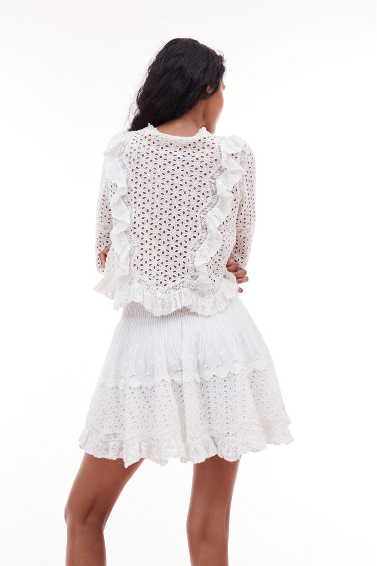 Mini skirt with eyelet details featuring a smocked waistband, and tiny lace details at the sweep.
