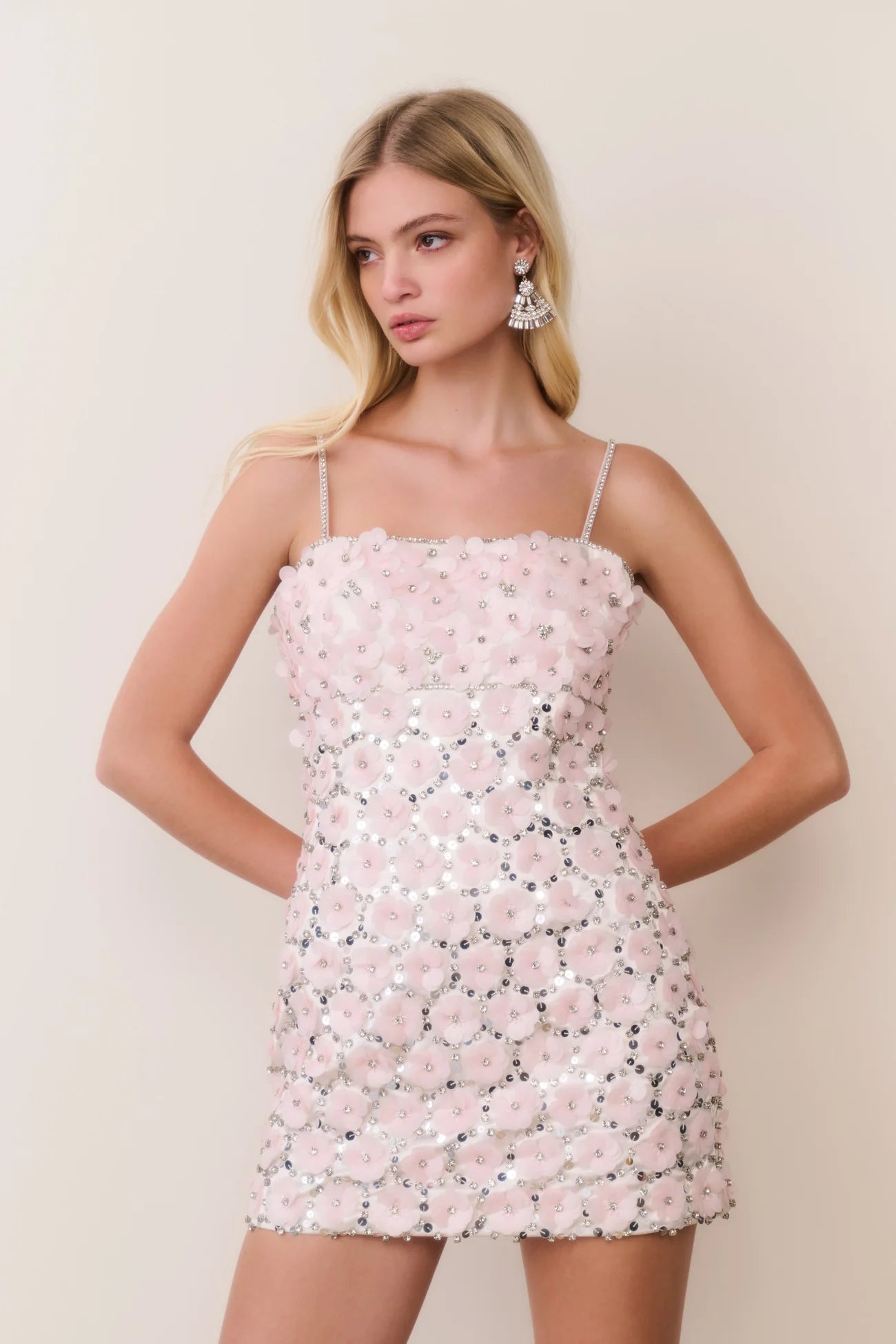 Women sitting in grass field wearing LoveShackFancy Slip Dresses