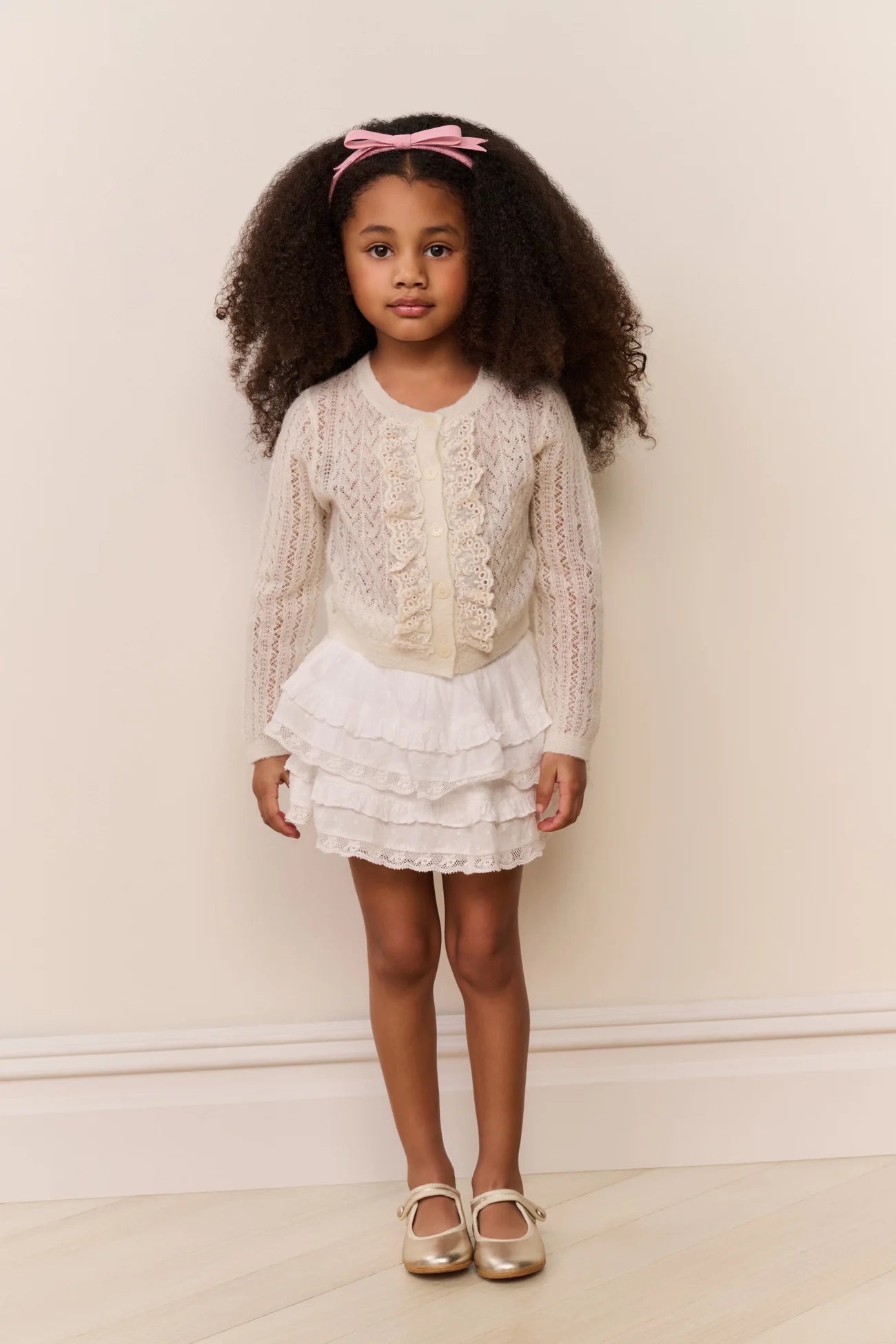 Women sitting in grass field wearing LoveShackFancy Slip Dresses