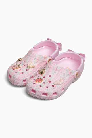 Pink children's clogs with floral pattern on a white background