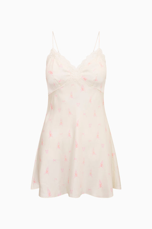 White slip dress with pink floral pattern on a white background